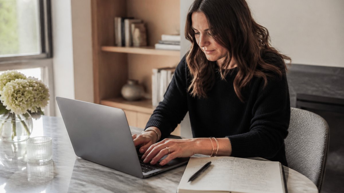 Startup founder drafting a personalized pitch to support PR strategies from a bright home office desk